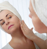 Woman looking at her wrinkles caused by UVA exposure