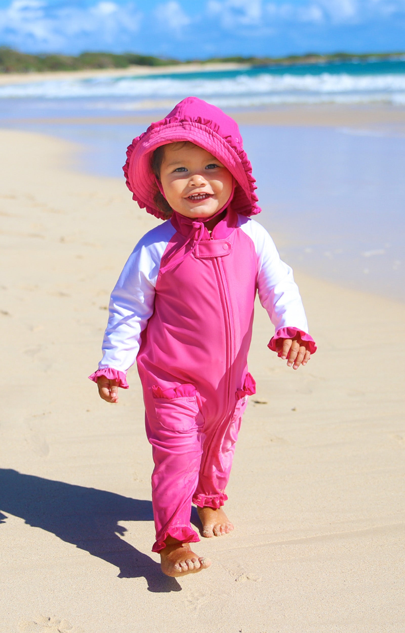 Baby girl in UV Skinz's baby girls long-sleeve swimsuit in bubblegum white|bubblegum-white