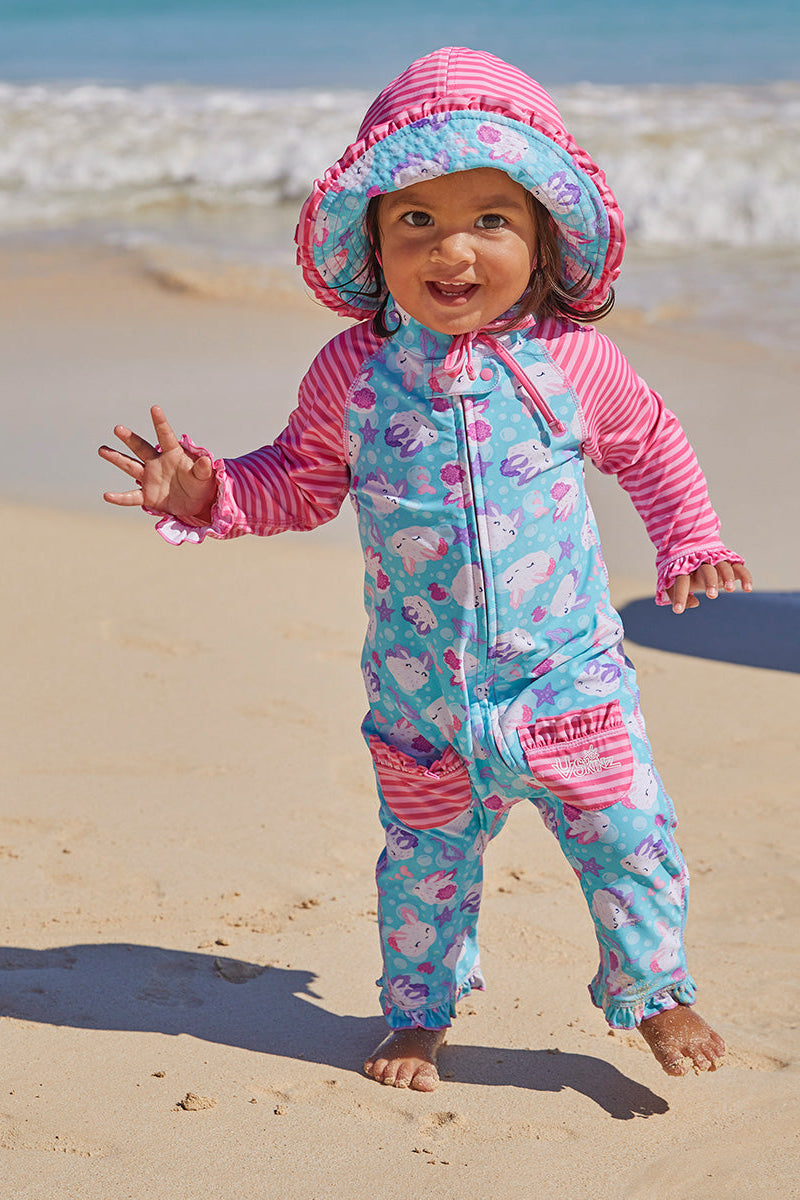 Little girl in UV Skinz's baby girls long-sleeve swimsuit in sea bunnies|sea-bunny-stripes