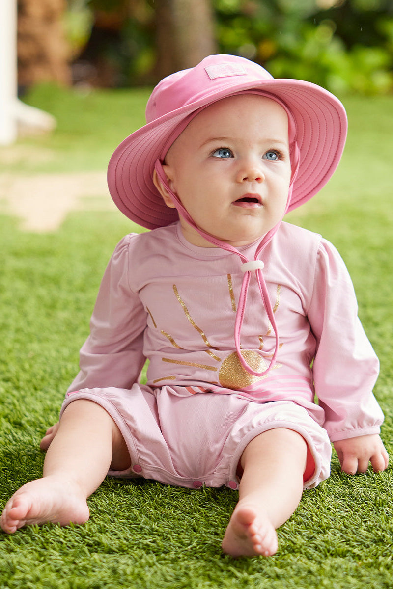 baby girl sitting in uv sunzie|glitter-sunshine