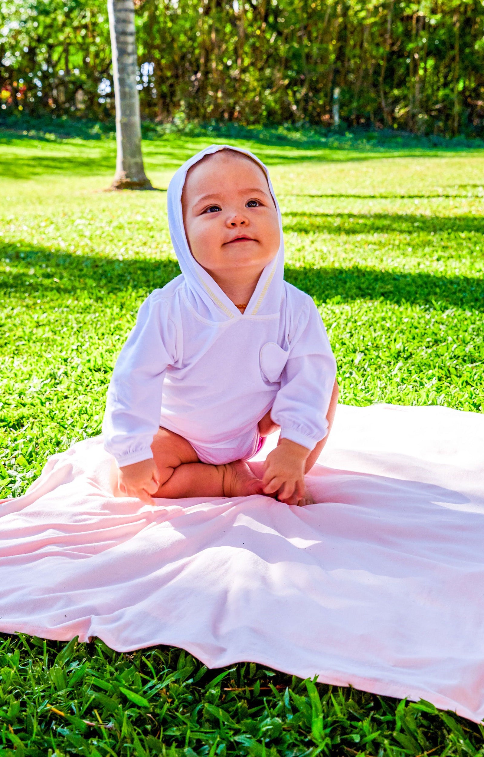 Baby on a Blanket in the Baby Girl's Hooded Sunzie in White|white