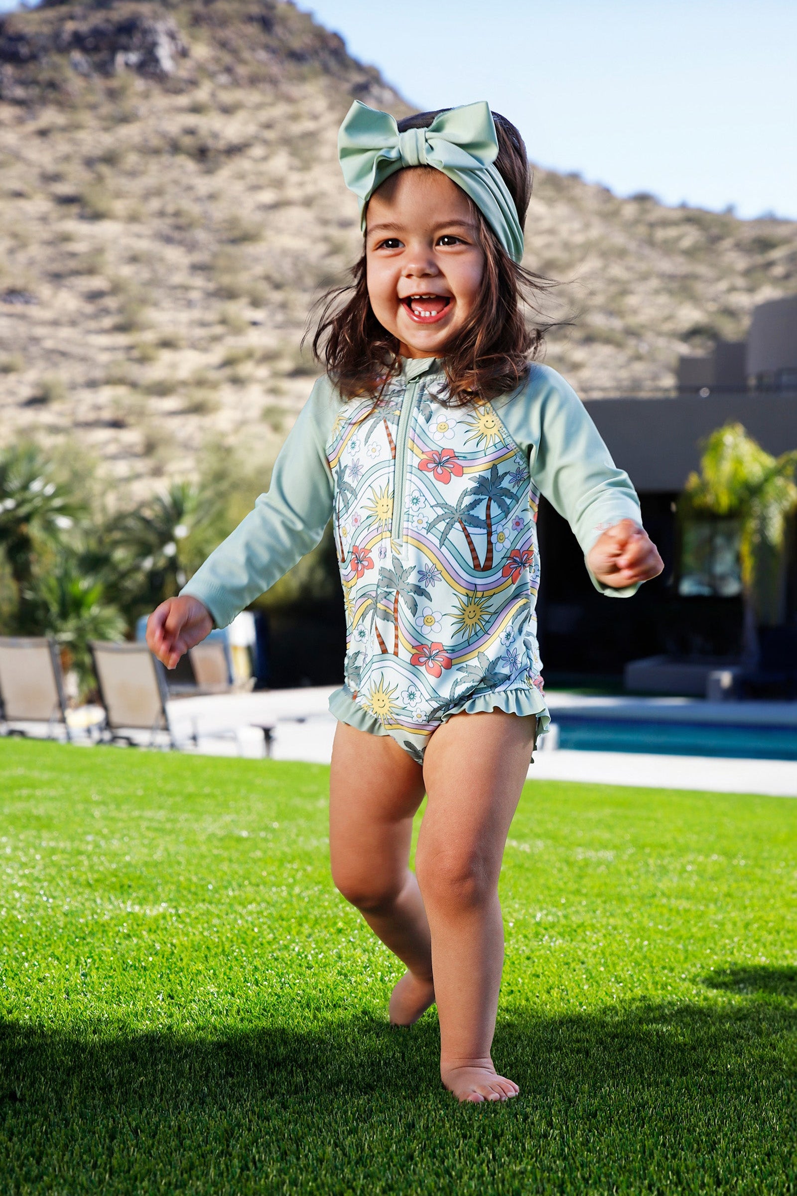 baby girl in long sleeve ruffled swim romper|retro-island