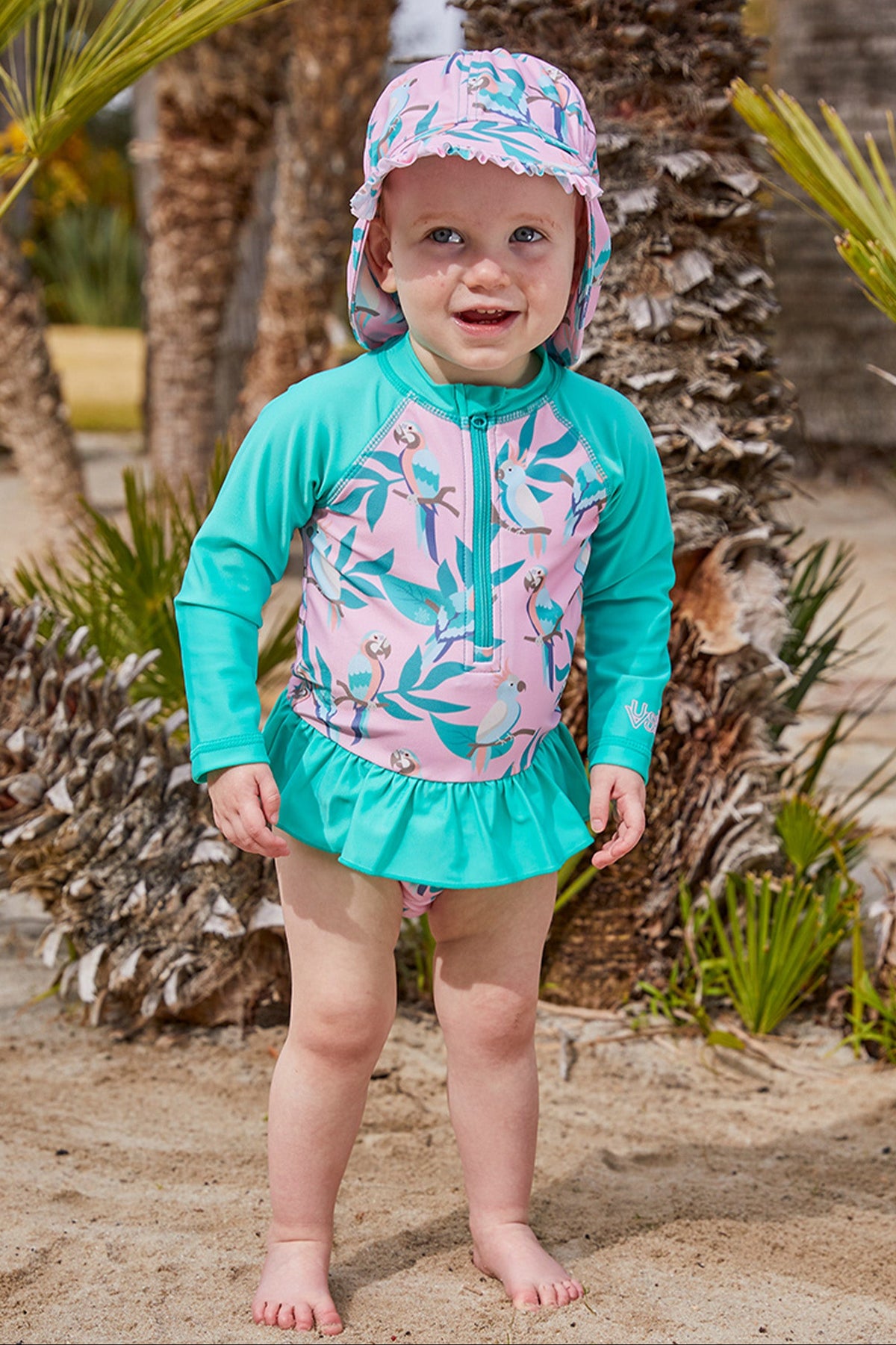 Baby girl in UV Skinz's baby girl's swim flap hat in birds in paradise