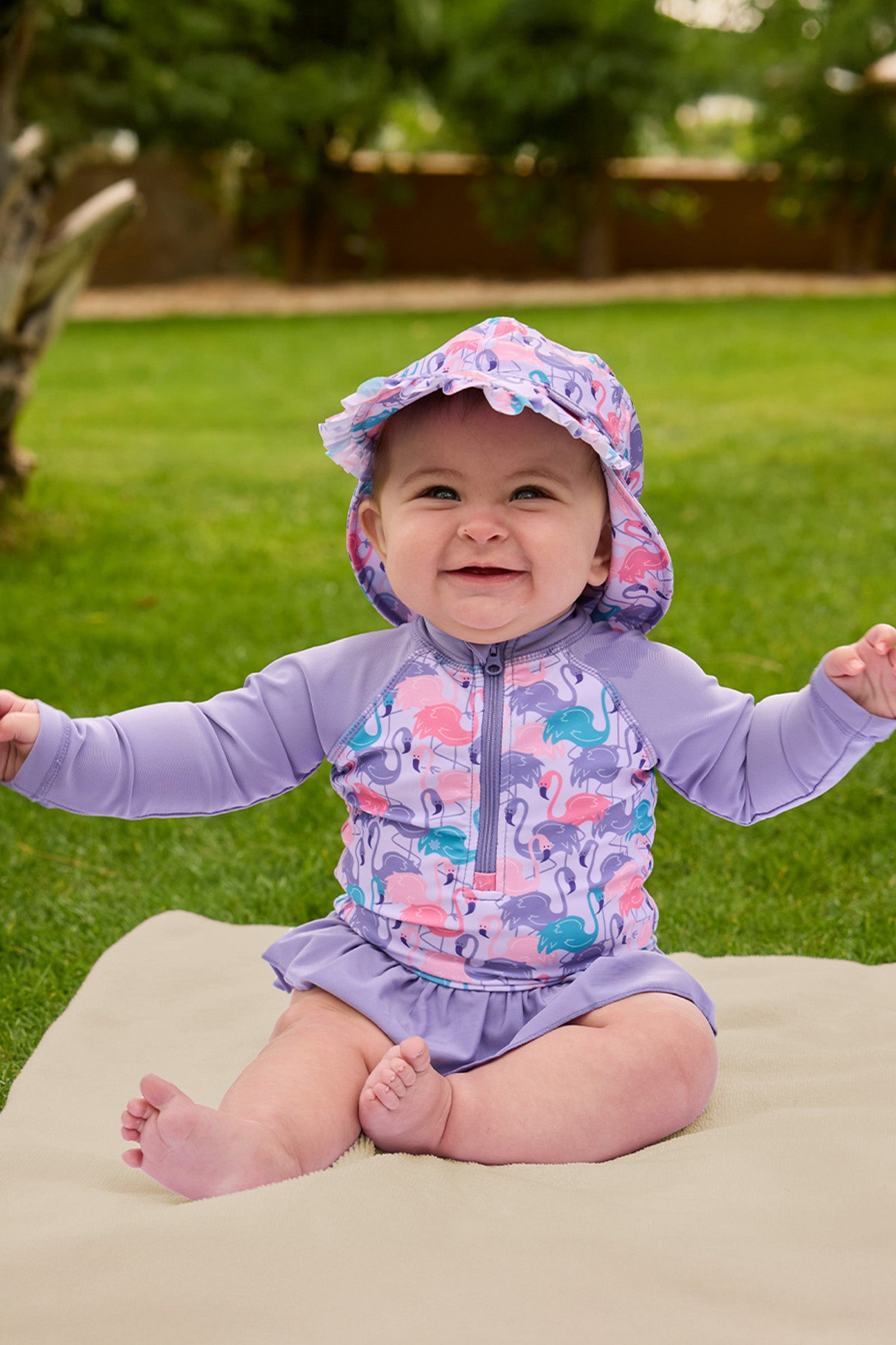 baby girl sitting in long sleeve ruffled swim suit|fancy-flamingos