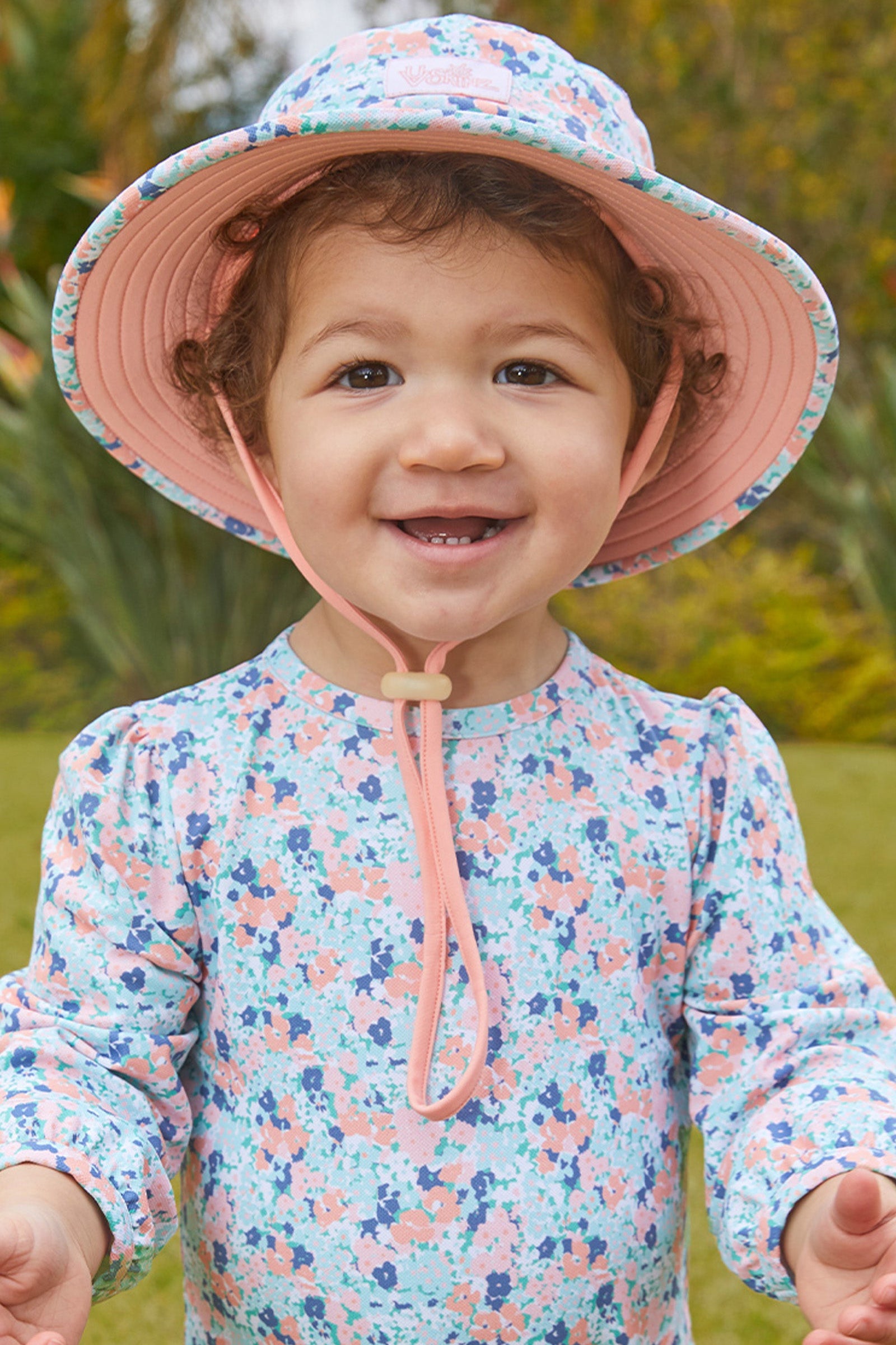 Baby girl in UV Skinz's baby girl's swim hat in meadow bloom|meadow-bloom