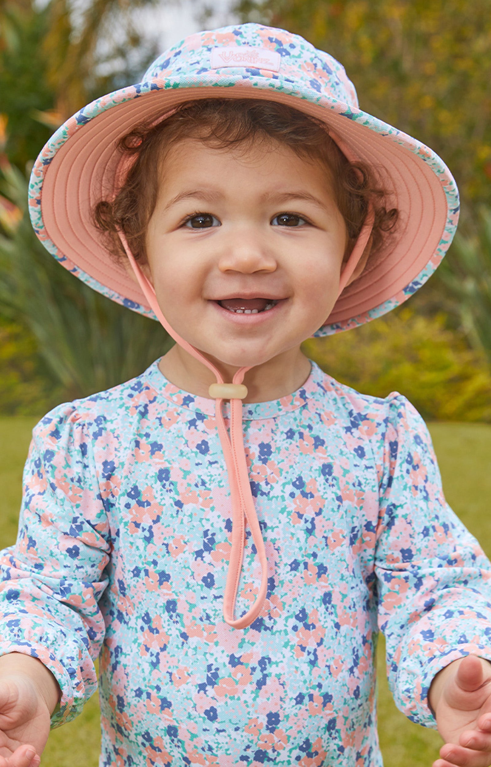 Baby girl in UV Skinz's baby girl's swim hat in meadow bloom|meadow-bloom