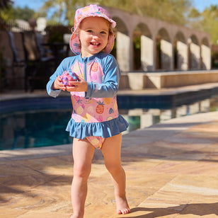 baby girl by pool in swim flap hat|pineapple-party