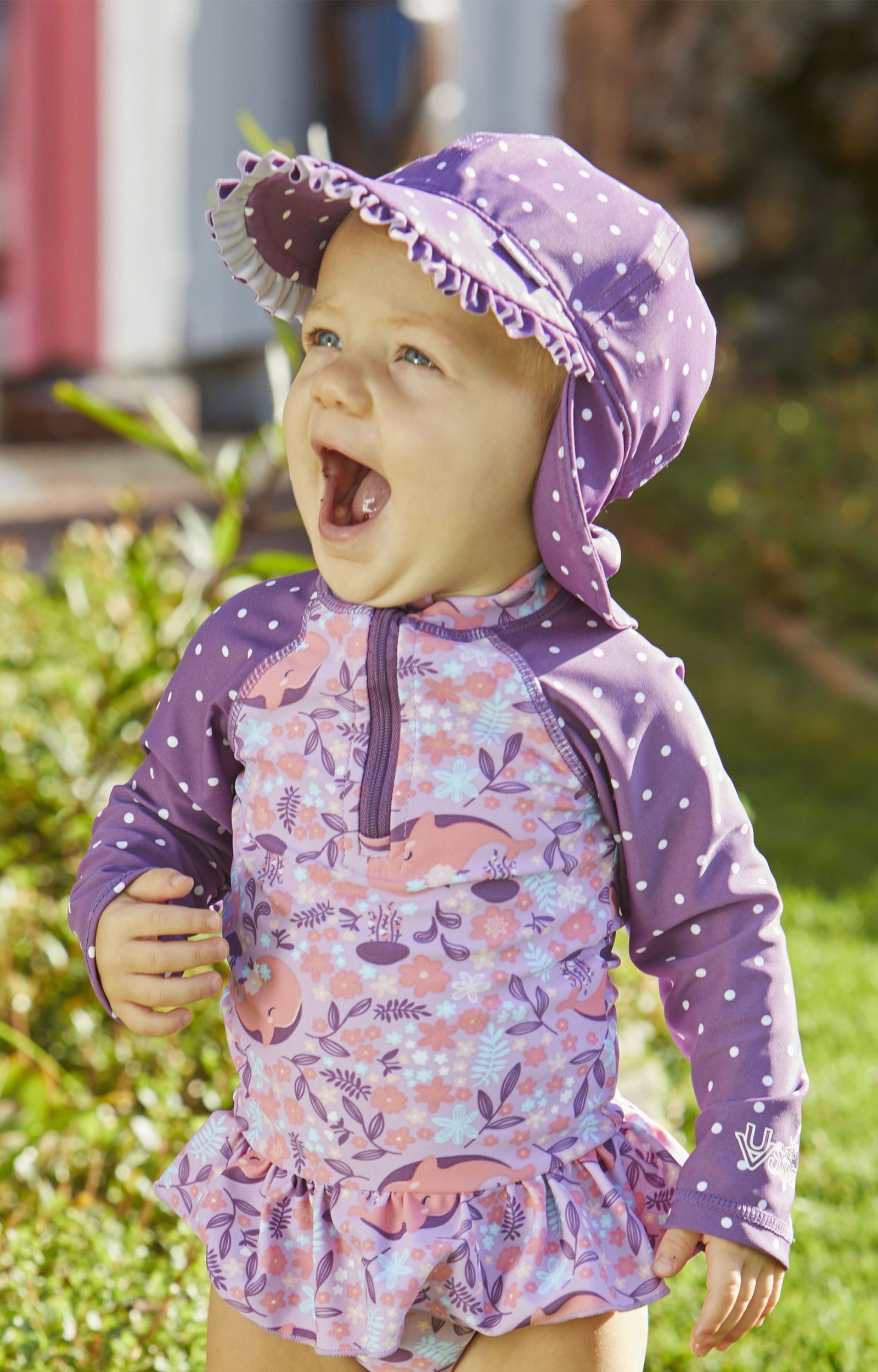 Baby girl in UV Skinz's girls swim flap hat in mulberry dot|mulberry-dot
