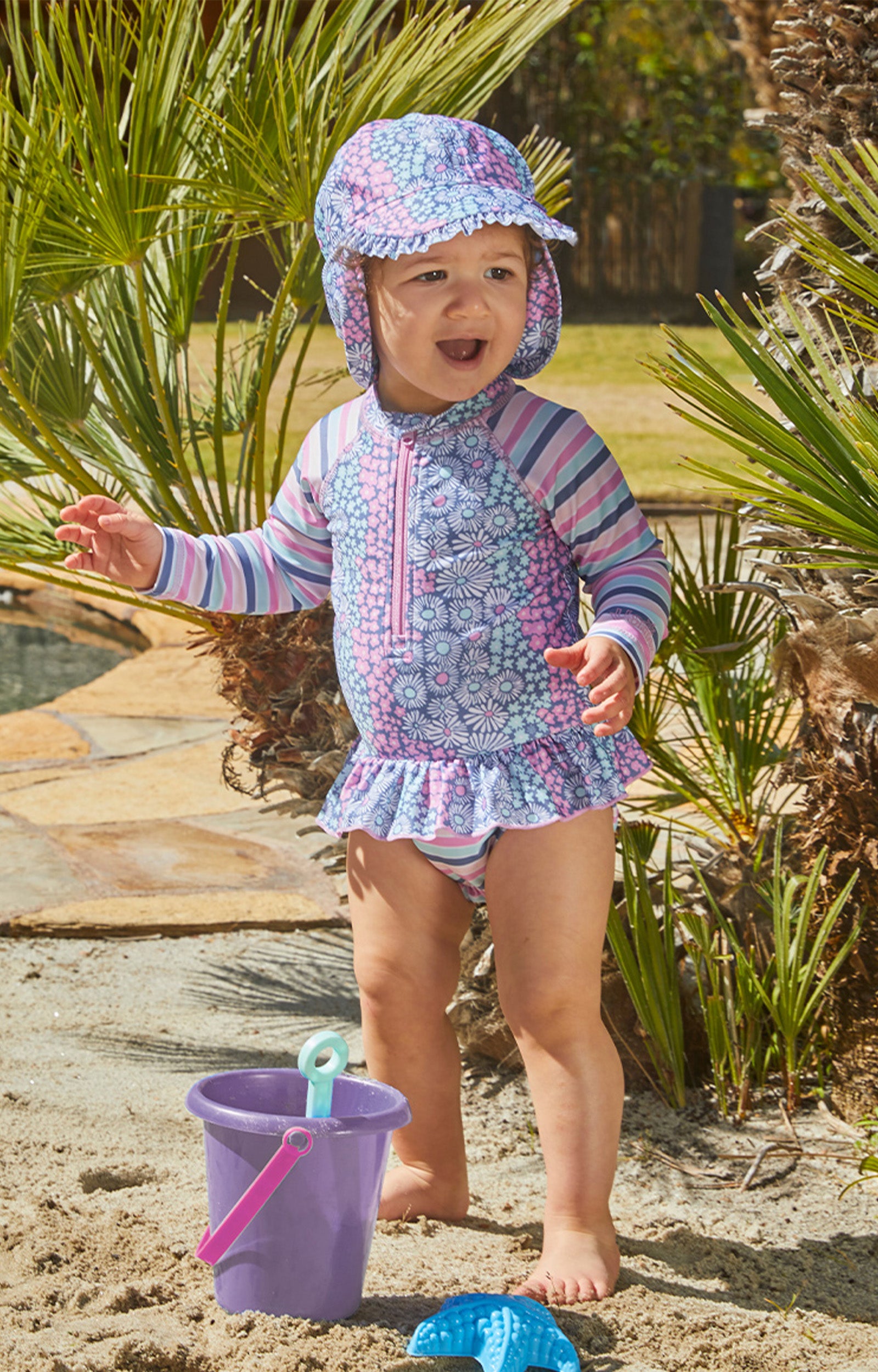 Baby girl in UV Skinz's baby girl's swim flap hat in wandering flowers|wandering-flowers