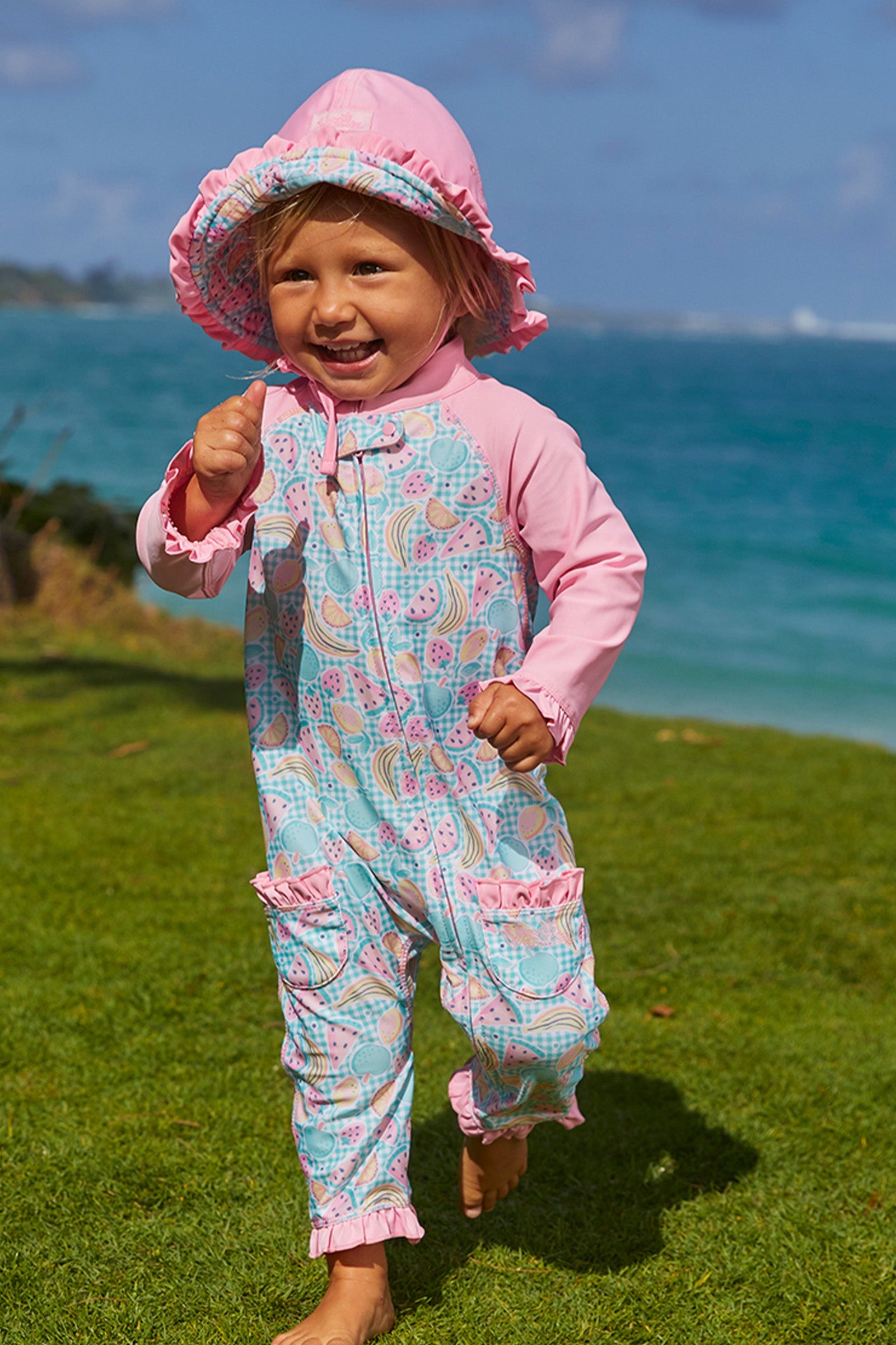 Baby girl in UV Skinz's baby girls long-sleeve swimsuit in fruit fiesta|fruit-fiesta