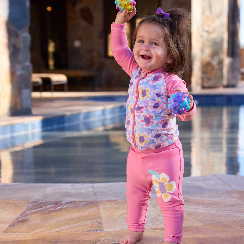 baby girl playing by pool in swim leggingz|wild-blossom