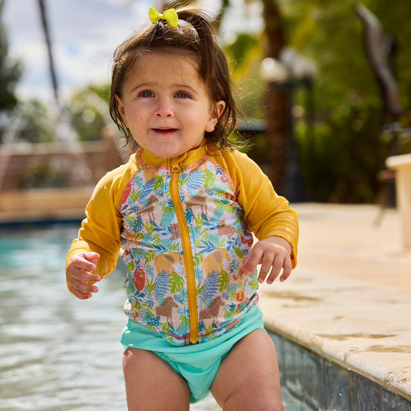 baby girl in full zip rashguard by pool|jungle-friends