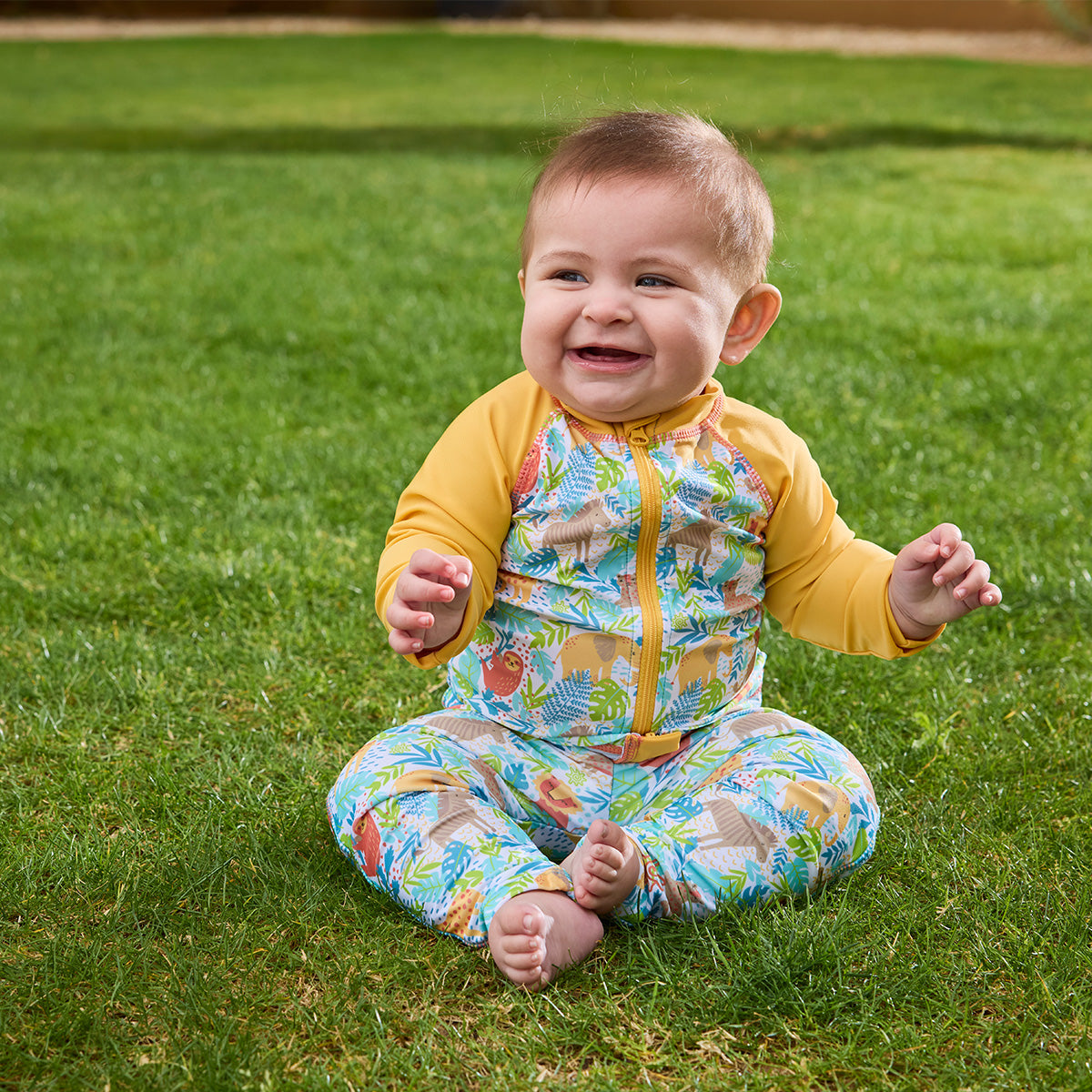 baby boy sitting in grass in full zip rashguard|jungle-friends
