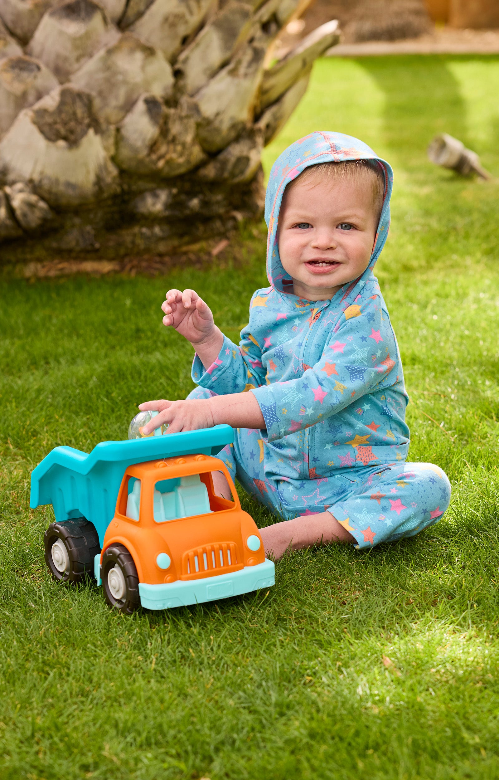 baby boy in hooded romper with toy truck|scribble-stars