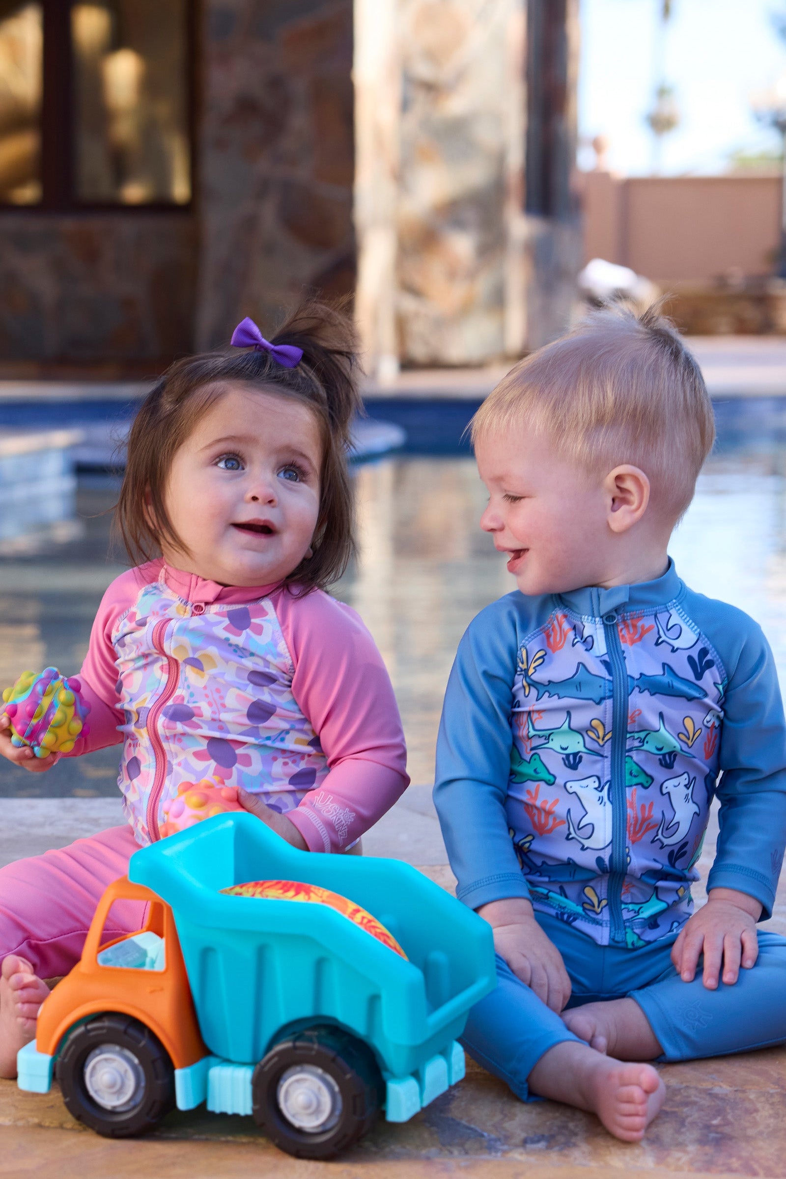 baby girl baby boy playing by pool with toys in swim leggingz|baltic-reef-shark