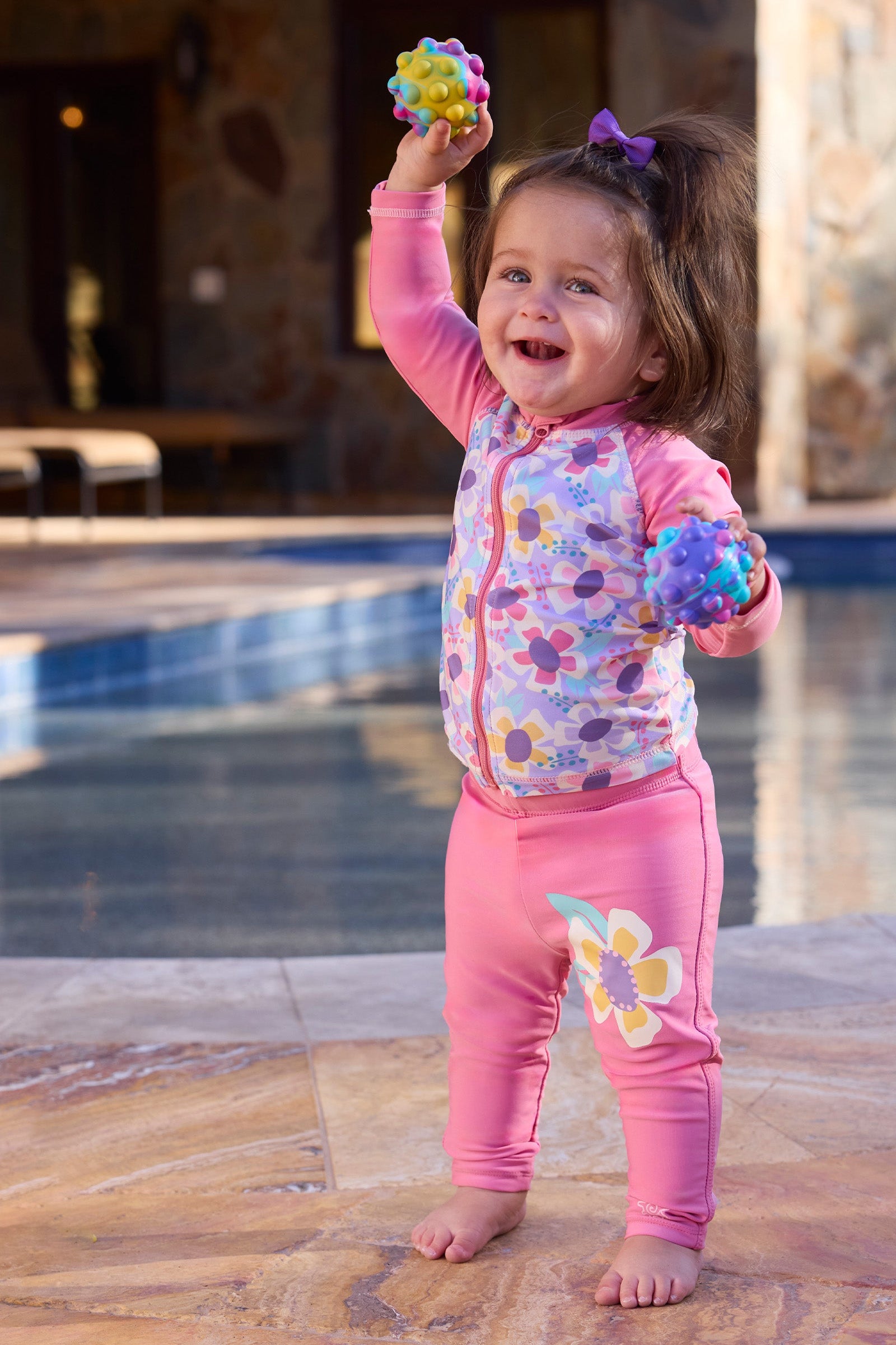 baby girl playing by pool in swim leggingz|wild-blossom