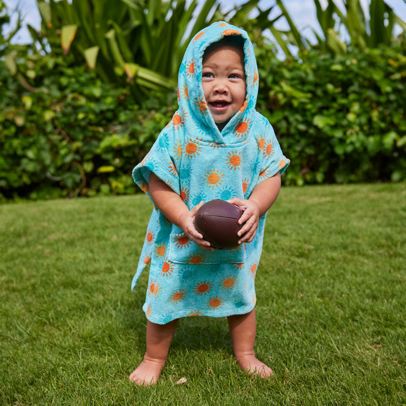baby with football in hooded beach poncho|sunny-days