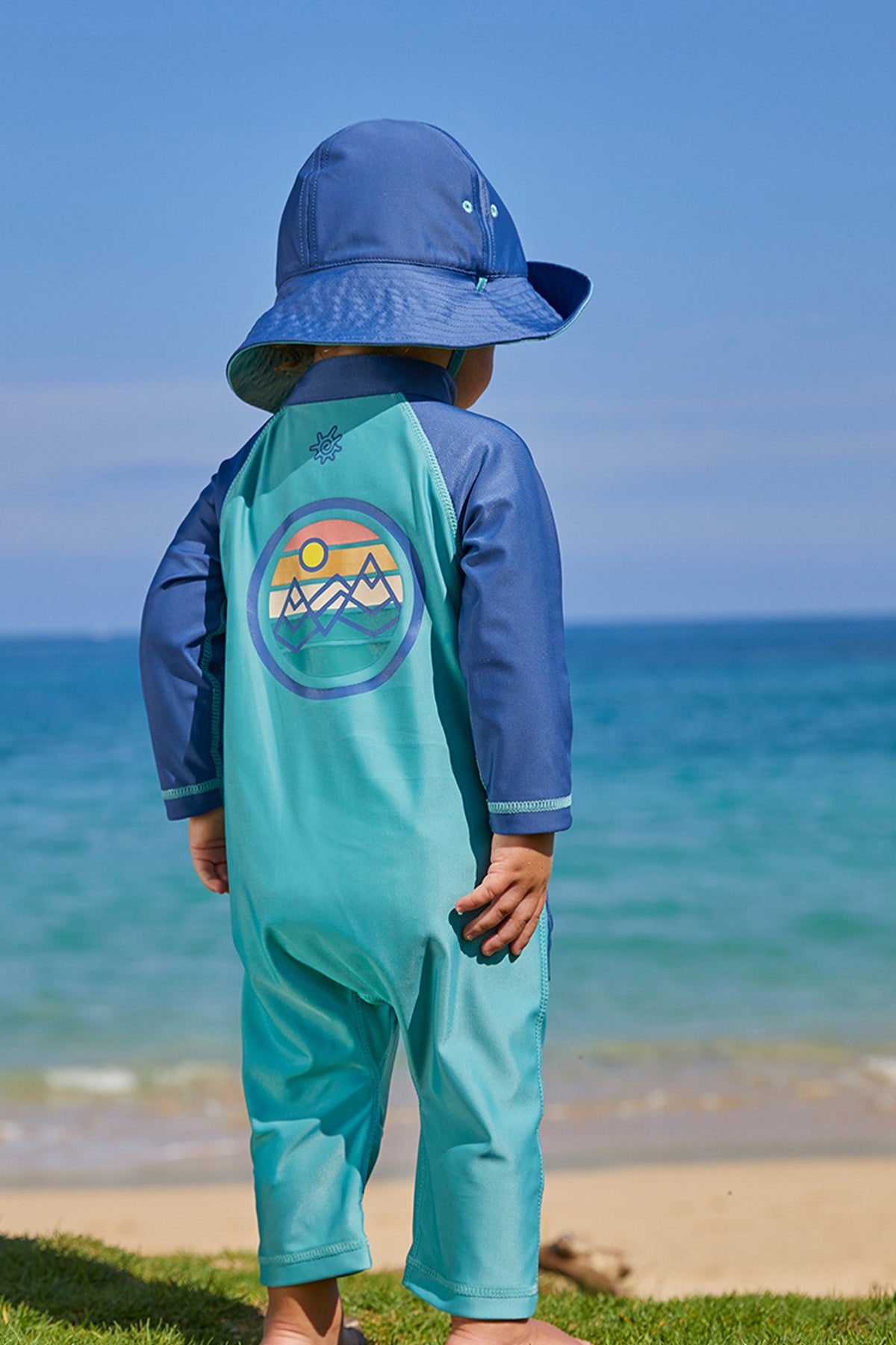 Baby boy on the beach in UV Skinz's baby boy's long-sleeve swimsuit in endless summer|endless-summer