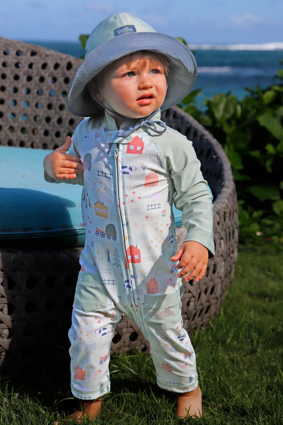 baby boy in grass in on the farm|on-the-farm