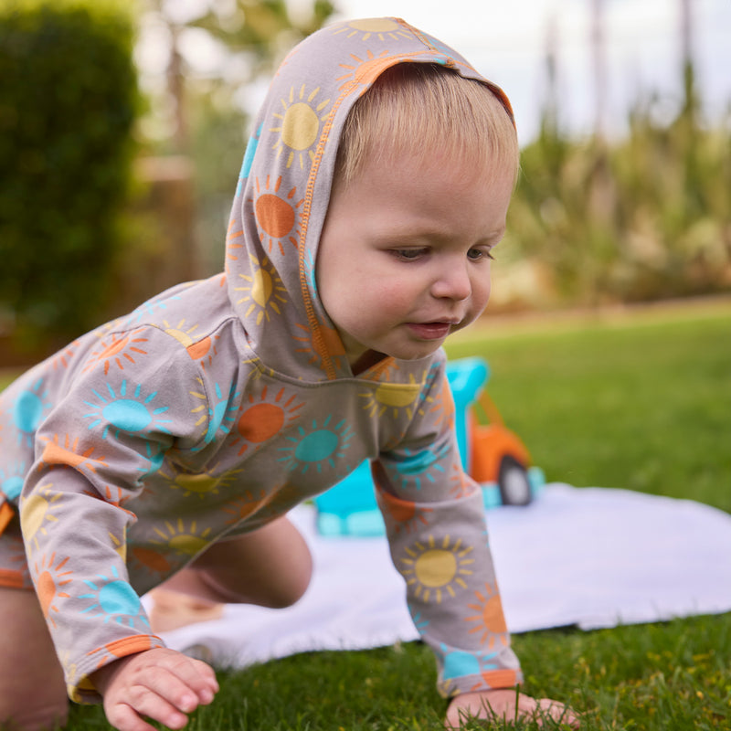 baby boy crawling in hooded sunzie