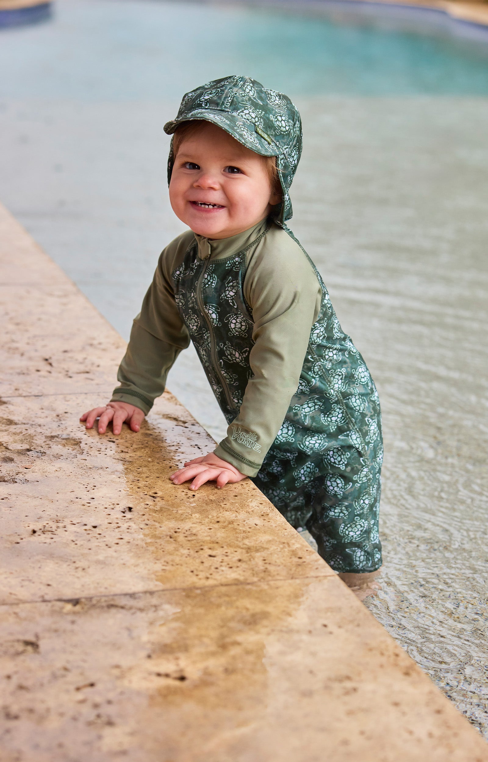 baby boy in pool in long sleeve swim romper|turtle-cove