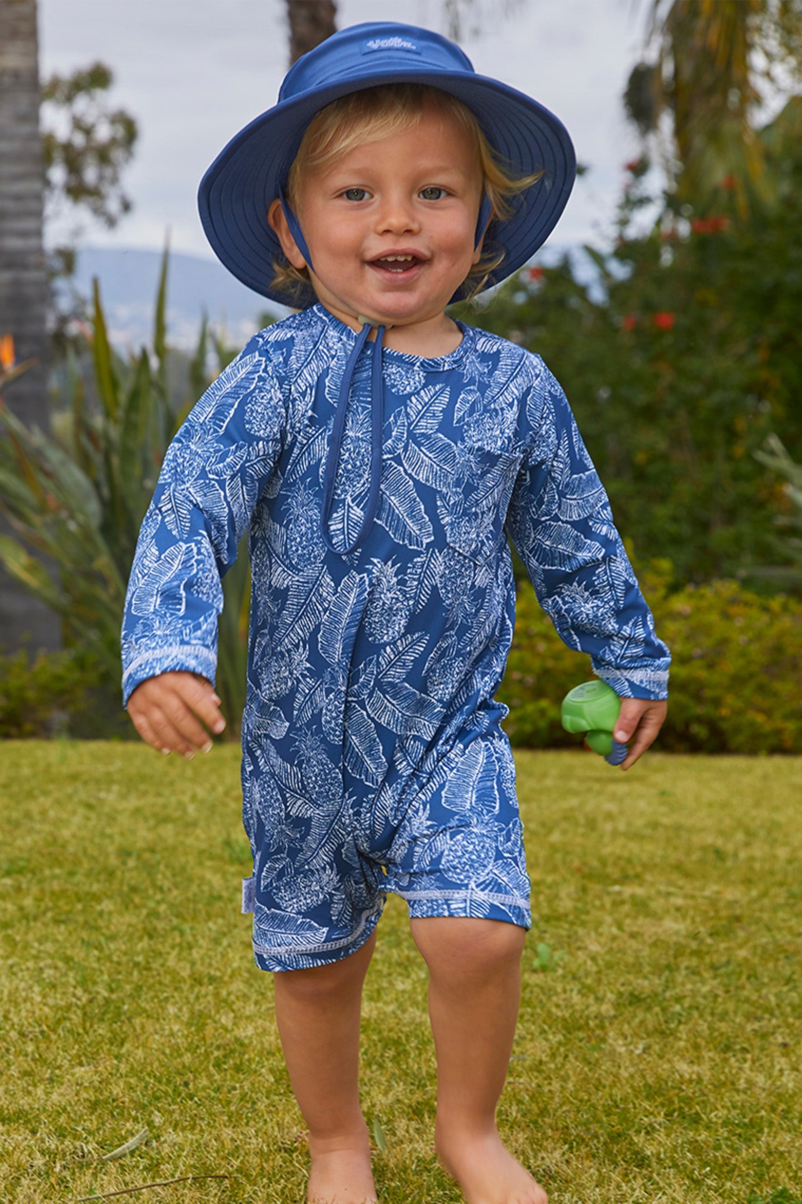 Baby boy in UV Skinz's baby boy's swim hat in washed navy|washed-navy