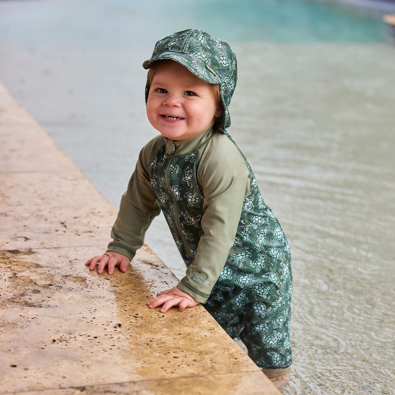 baby boy in pool in long sleeve swim romper|turtle-cove