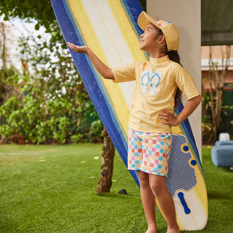 girl by surfboard in board shorts|malibu-sunset-stripe