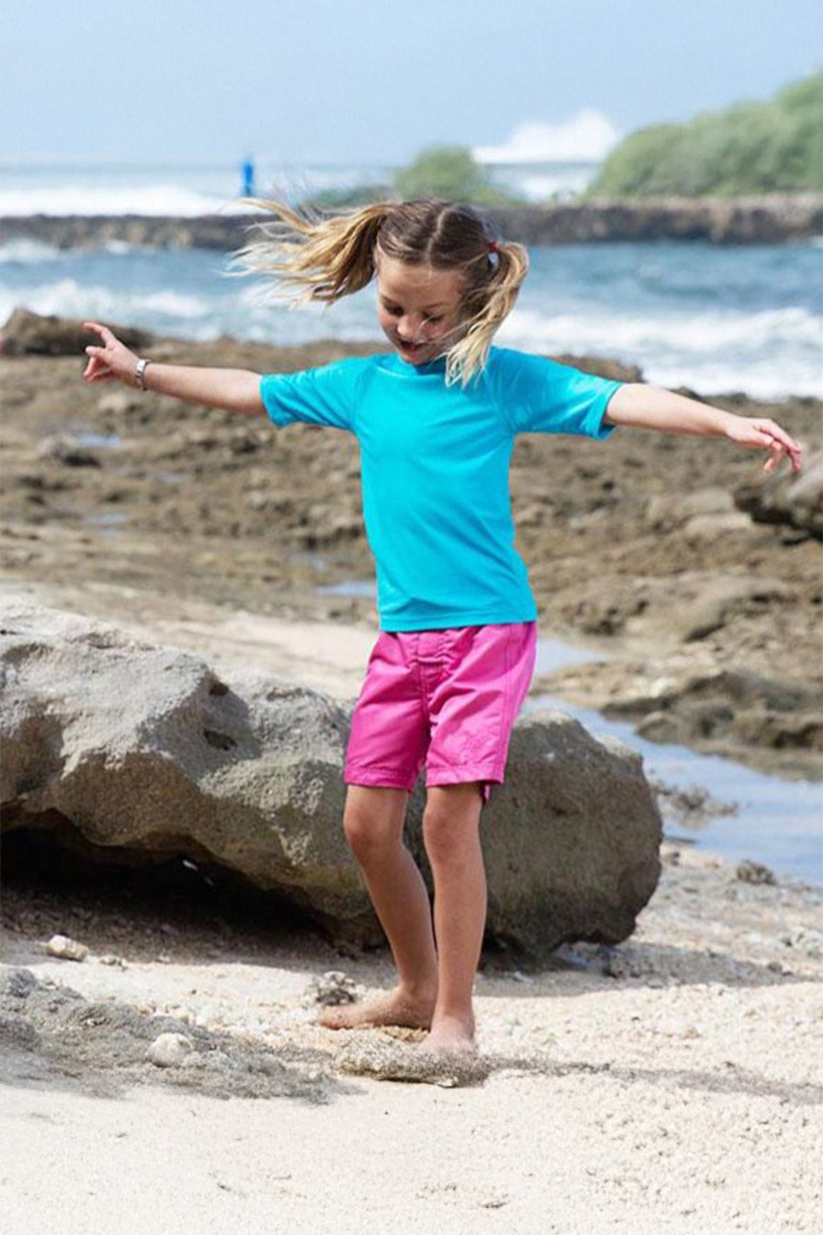 Little girl in the girl's board shorts in bubblegum|bubblegum
