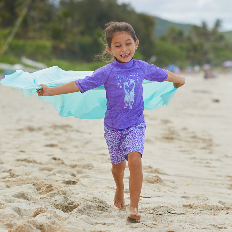 Little Girl Running Down the Beach in Girl's Board Shorts in Purple Spots|purple-spots