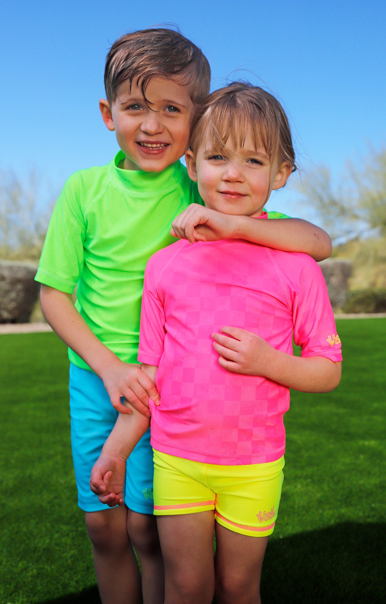 girl having fun in grass with girls neon reversible active swim shorts in neon yellow|neon-sorbet-neon-yellow