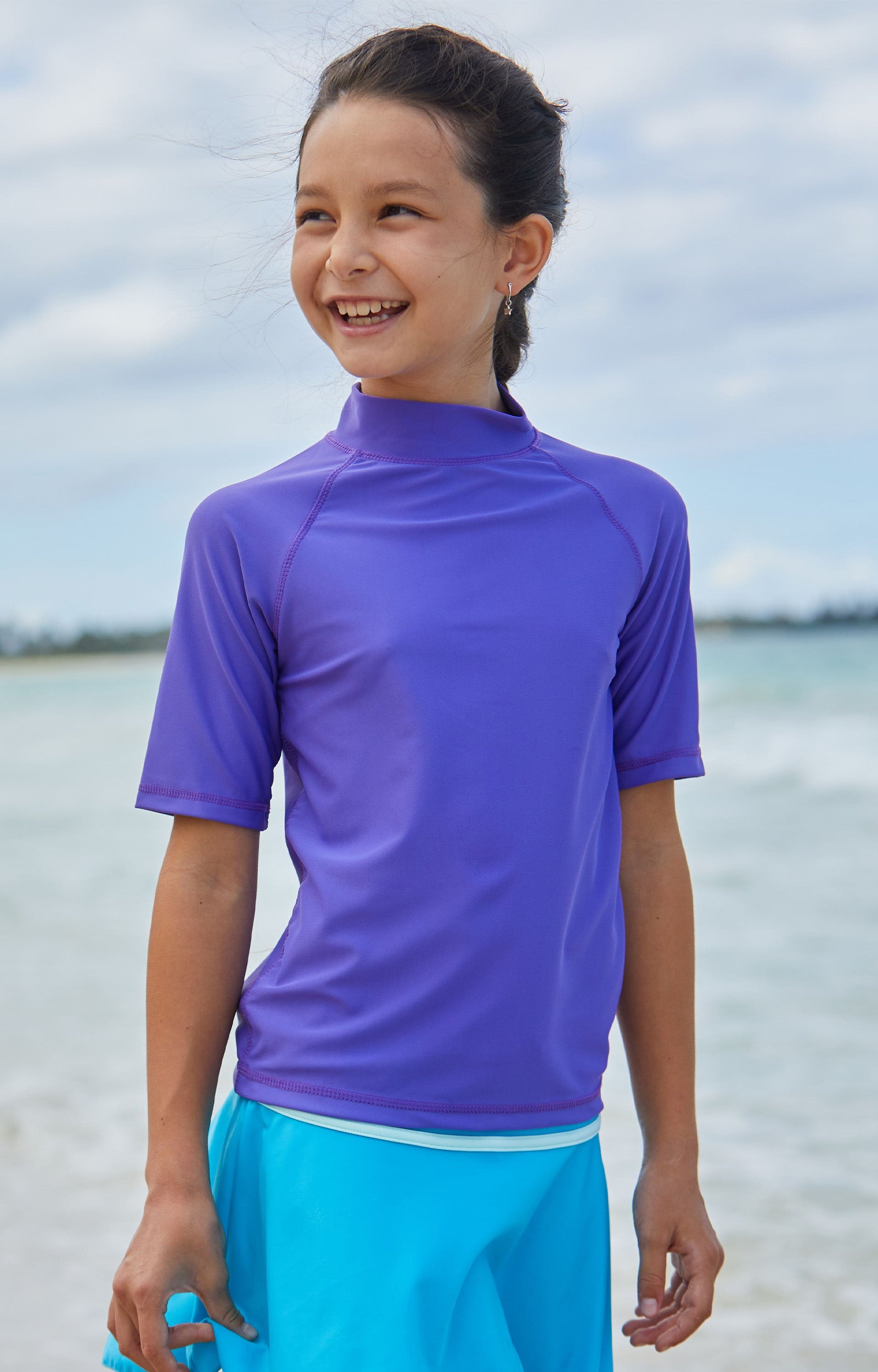 Young girl in the kid's short sleeve swim shirt in purple|purple