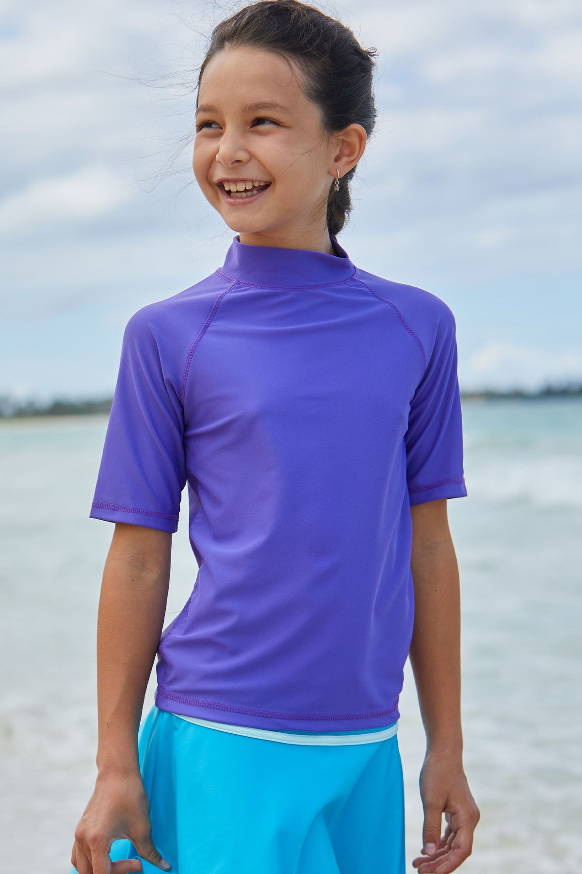 Young girl in the kid's short sleeve swim shirt in purple|purple
