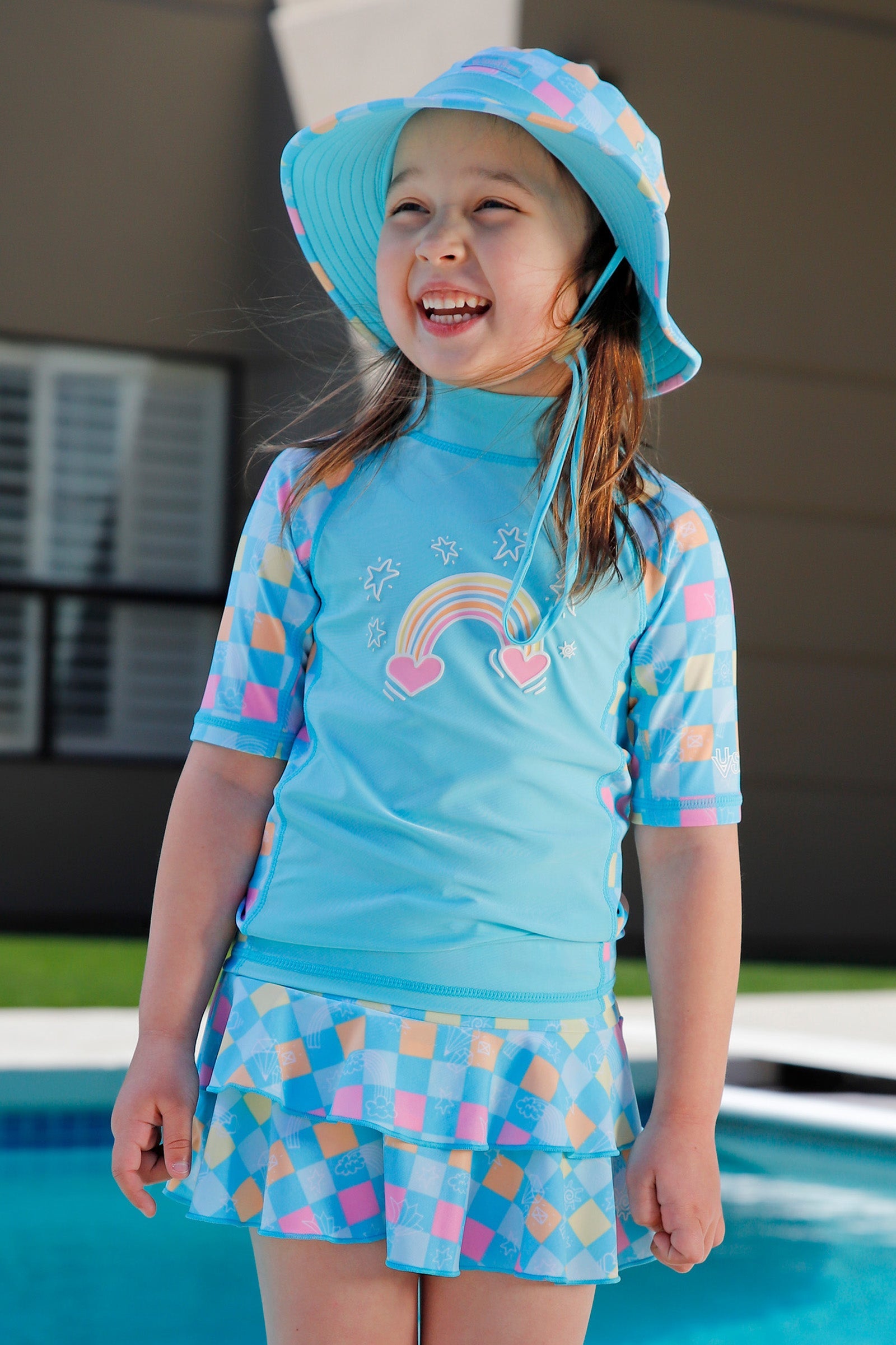 girl laughing by pool in short sleeve sunny swim shirt|treasure-checkers