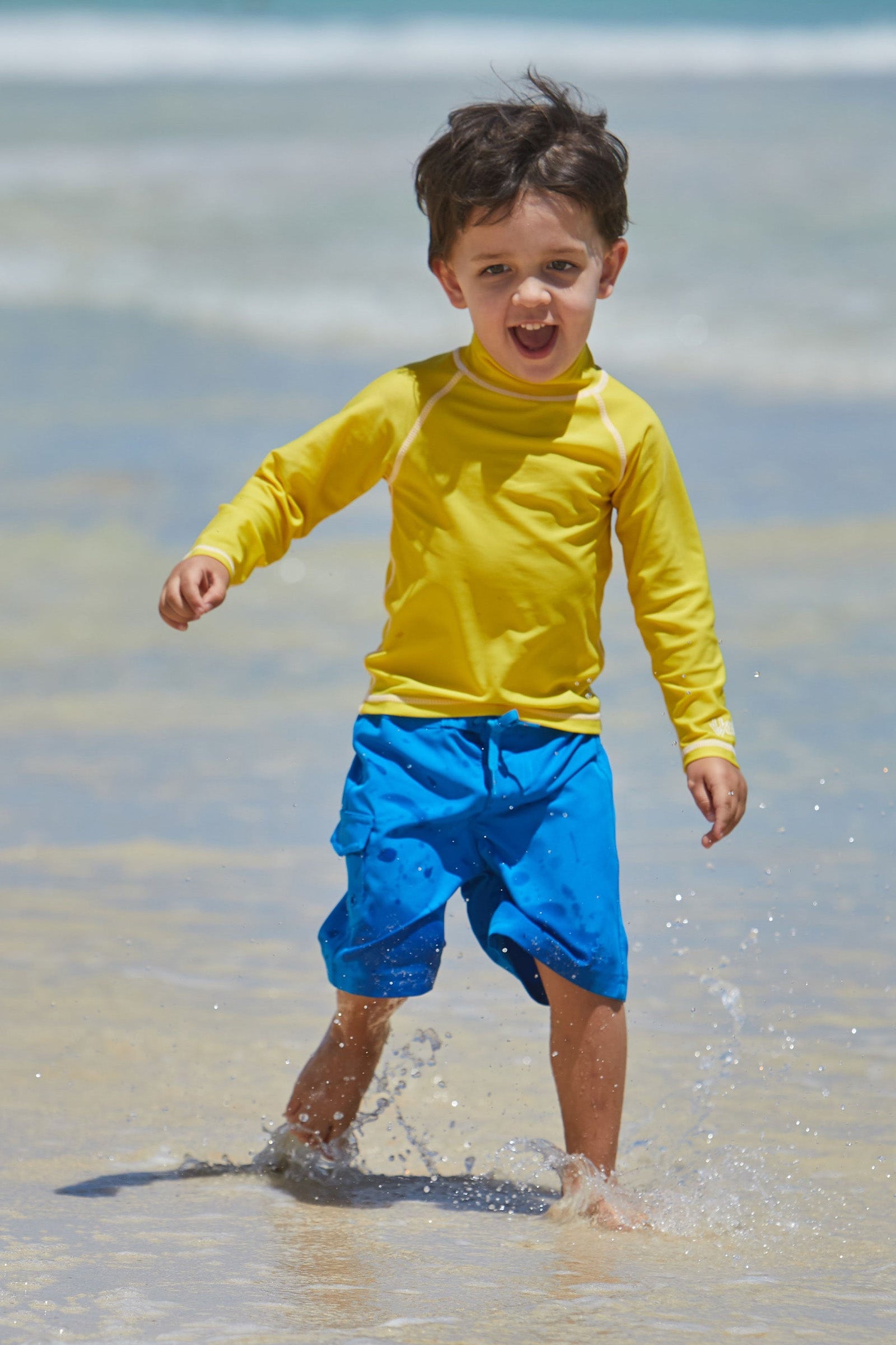 Little Boy on the Beach in the Boy's Classic Board Shorts in Roya|royal