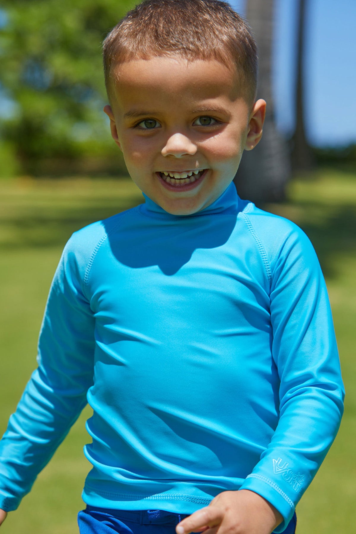 Little boy in the kid's long sleeve swim shirt in aqua|aqua