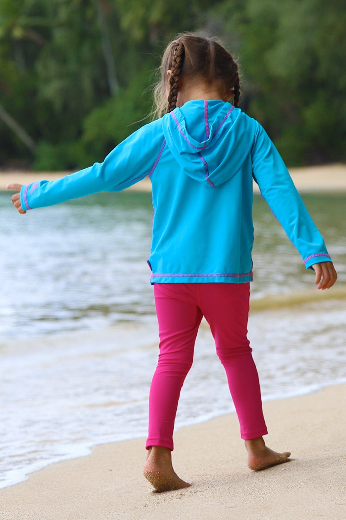 Little girl in UV Skinz's girls pullover hoodie in aqua|aqua