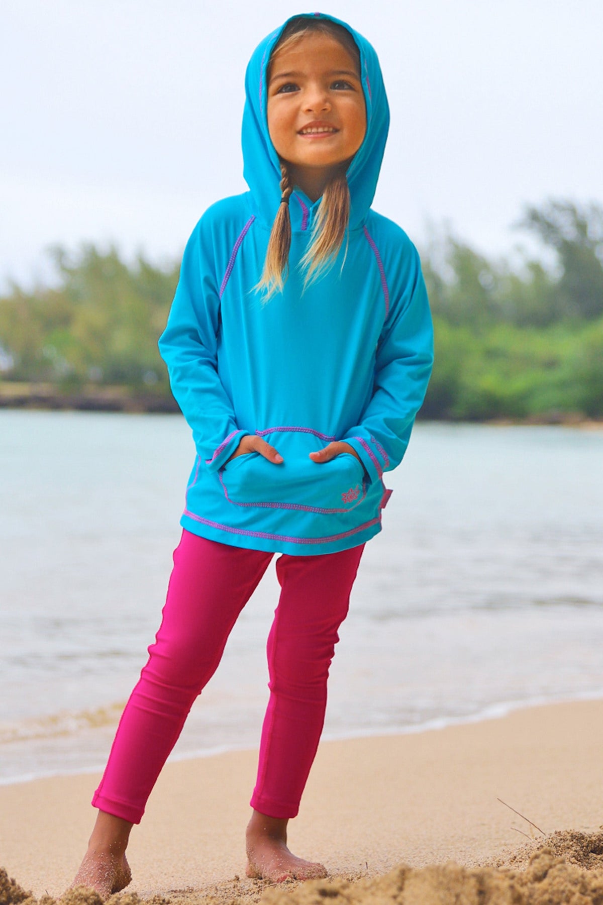 Little girl wearing UV Skinz's girls pullover hoodie in aqua|aqua