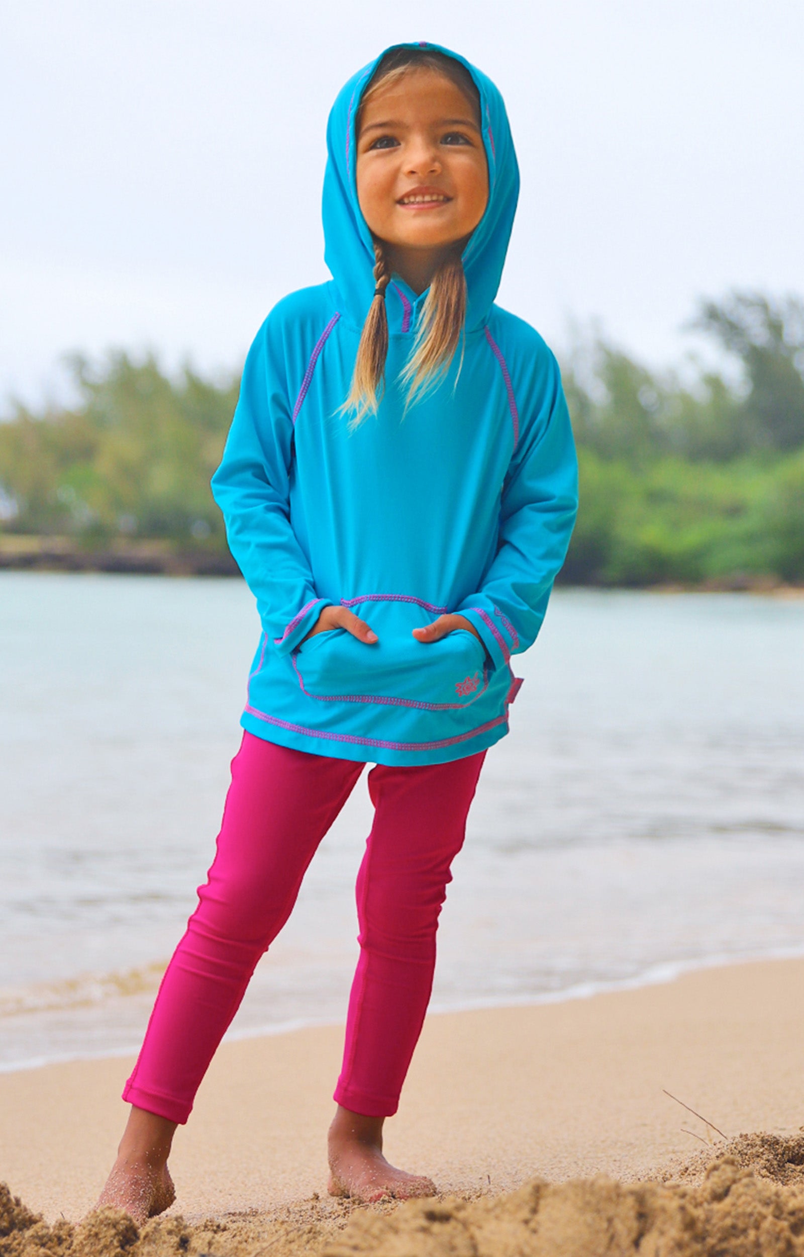 Little girl wearing UV Skinz's girls pullover hoodie in aqua|aqua