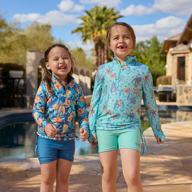 girls laughing in half zip ruched sun swim shirt poolside|dancing-starfish