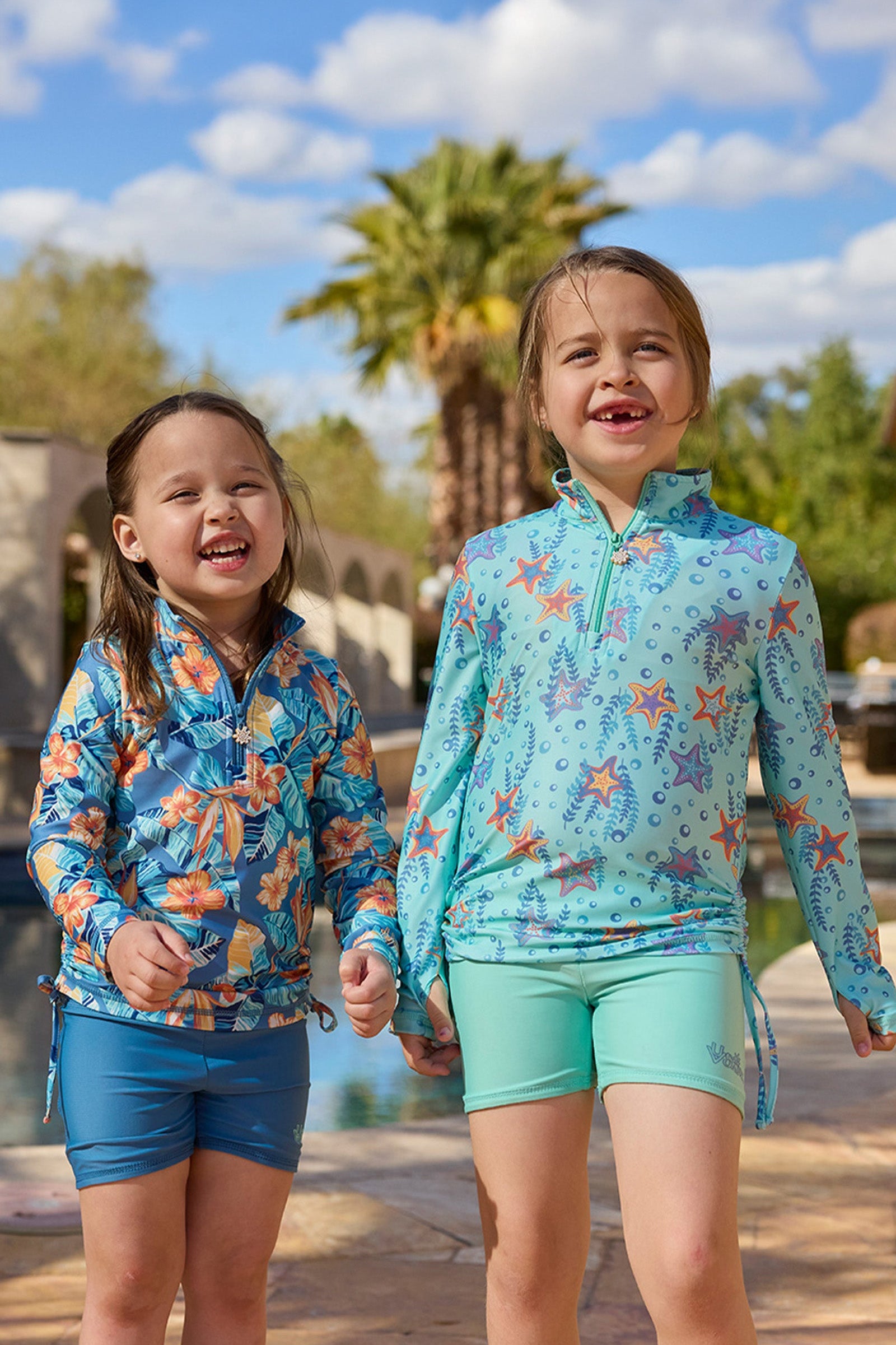 girls laughing in half zip ruched sun swim shirt poolside|dancing-starfish