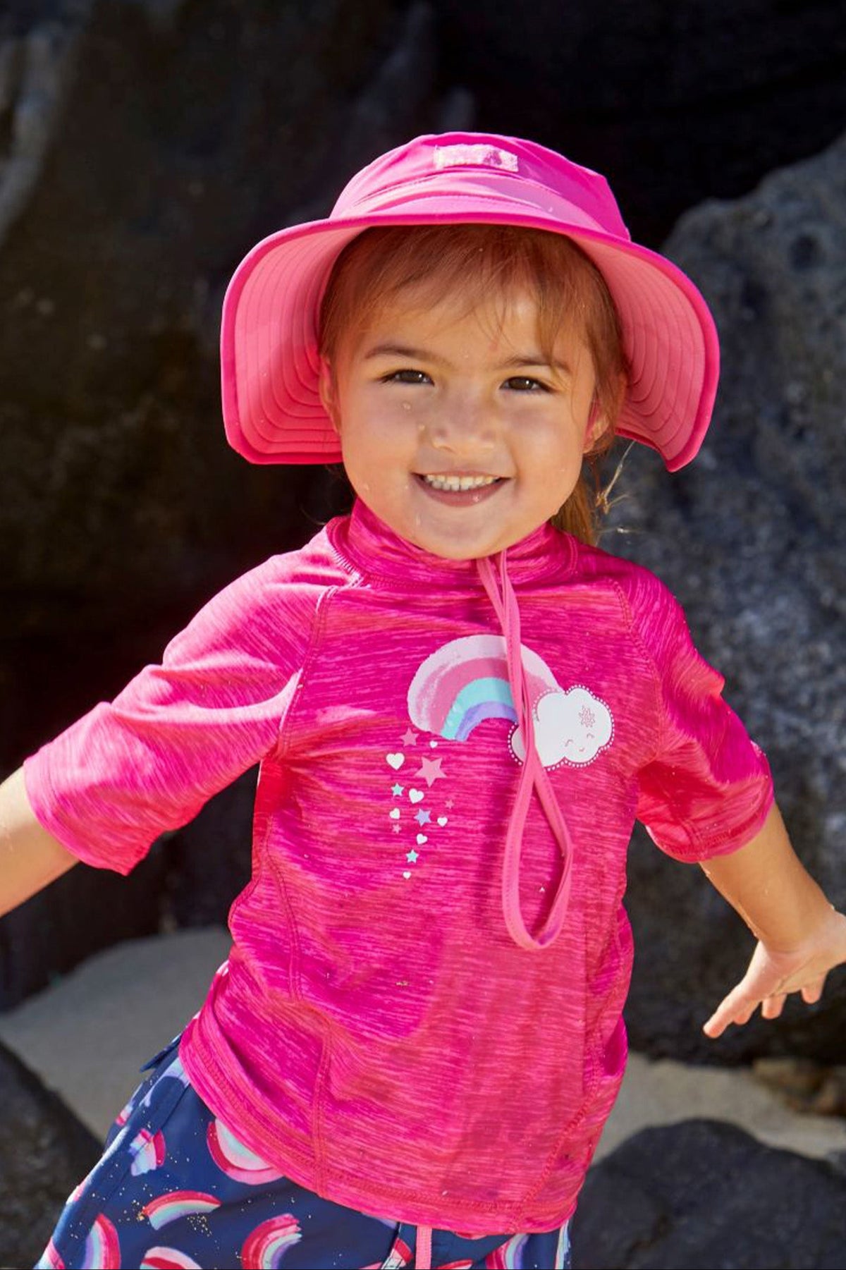 Little girl wearing UV Skinz's hot pink bubblegum swim hat|hot-pink-bubblegum