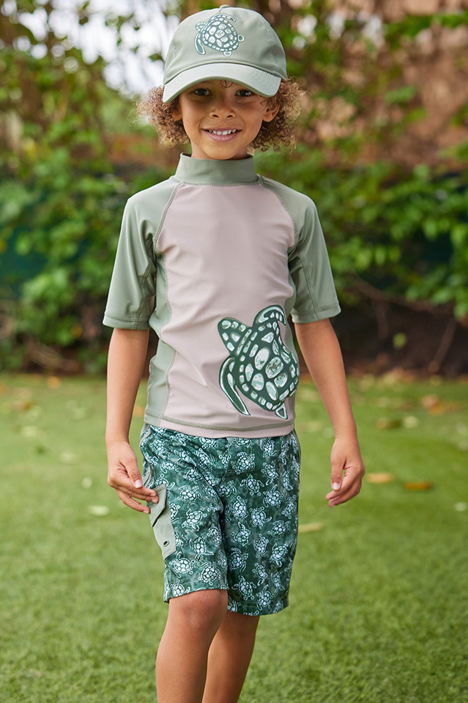 boy in racer stripe board shorts|turtle-cove