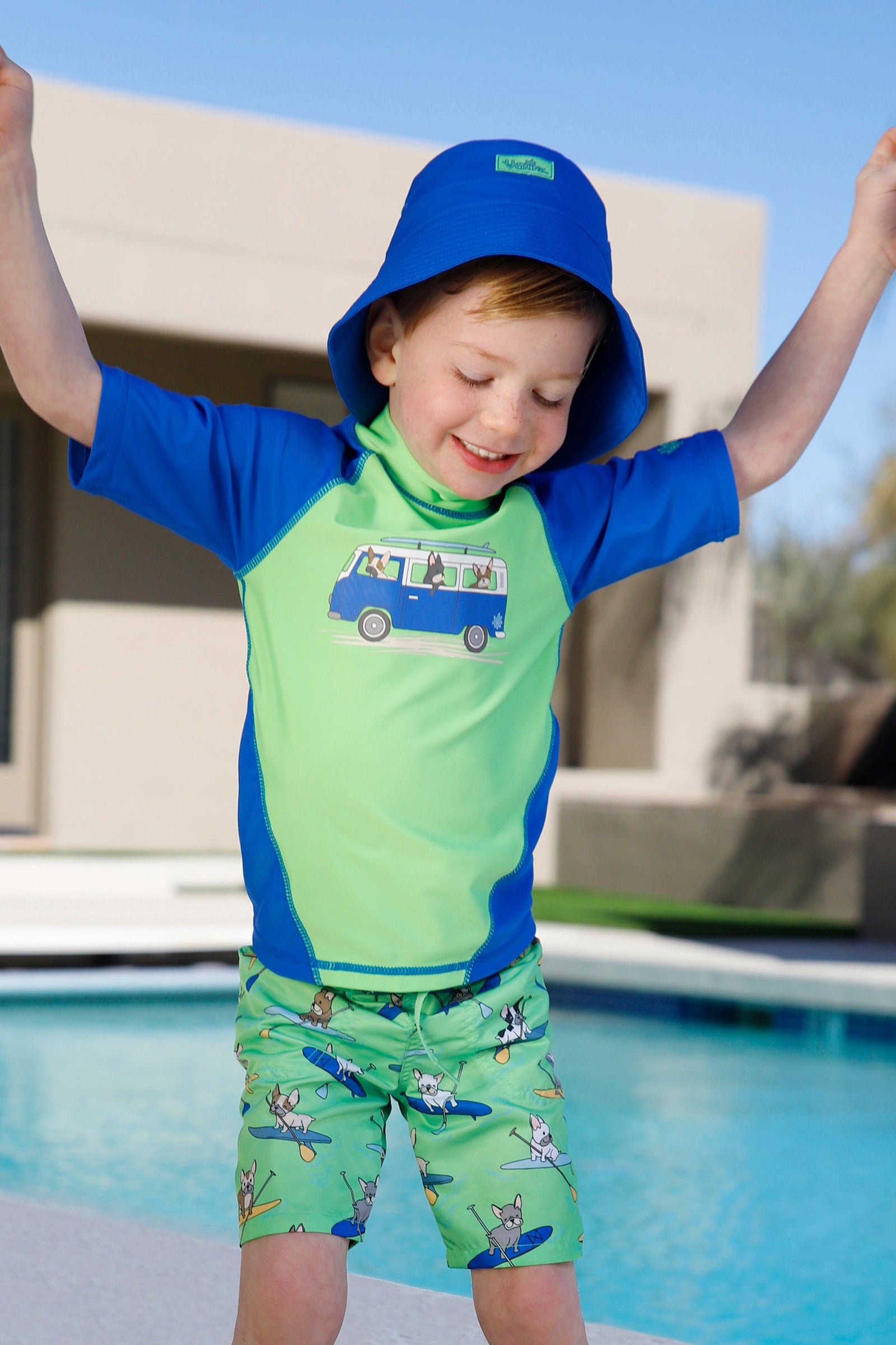 boy by the pool in magic beach shorts|magic-pups