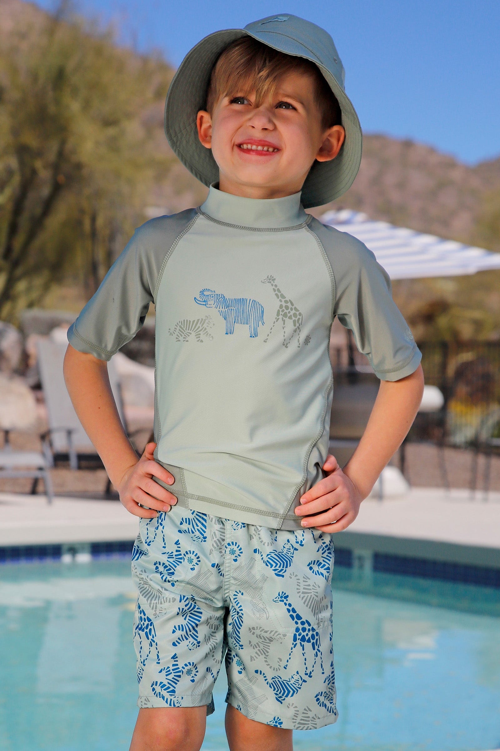 boy by the pool in magic beach shorts|magic-zoo