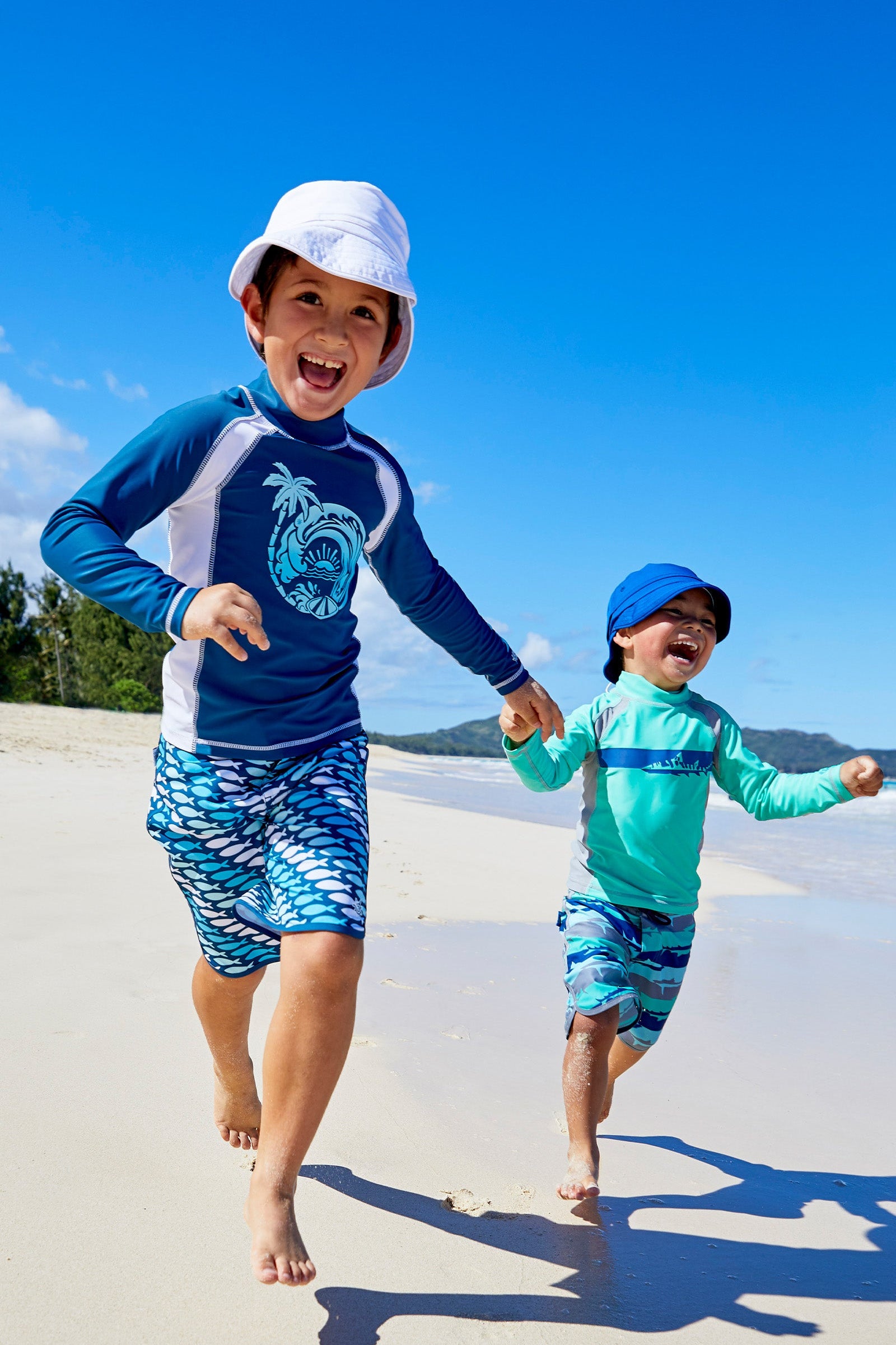 Little boys wearing UV Skinz's Boy's long sleeve active swim shirts in white octopus stripe|white-octopus-stripe