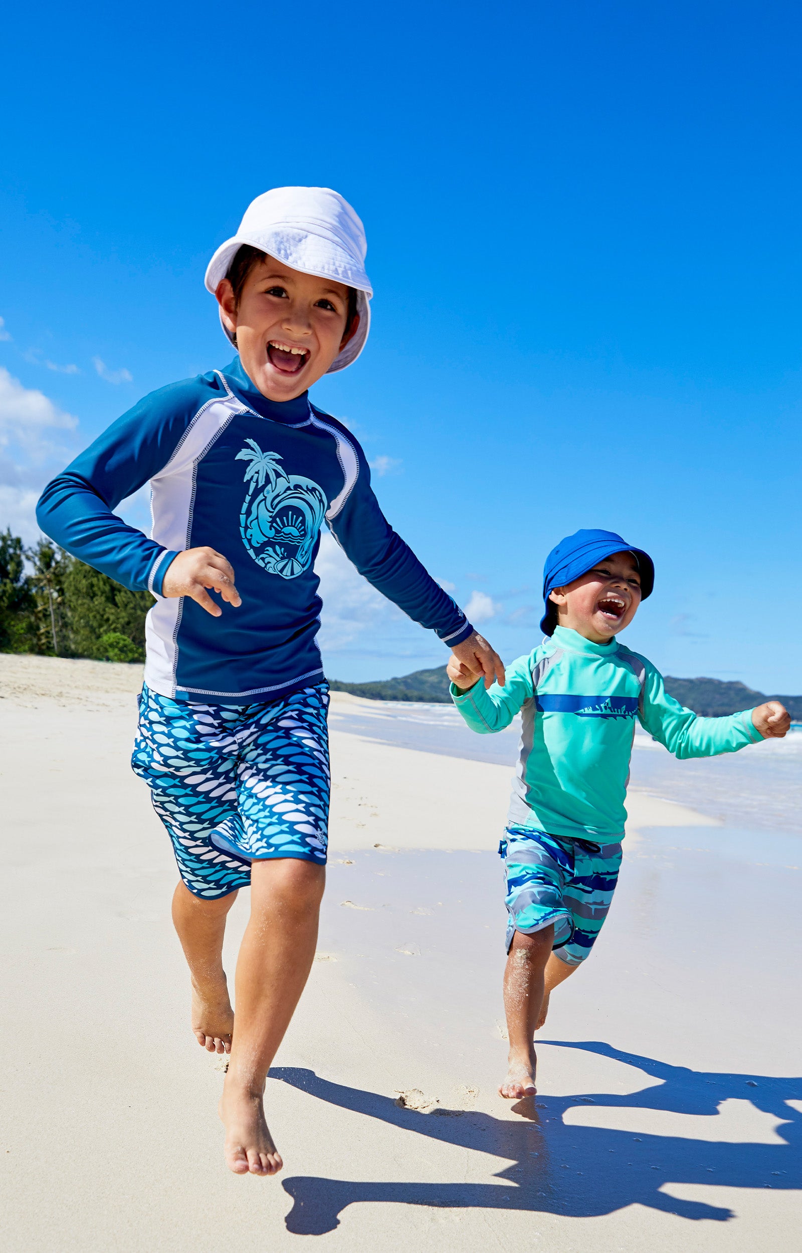 Little boys wearing UV Skinz's Boy's long sleeve active swim shirts in white octopus stripe|white-octopus-stripe