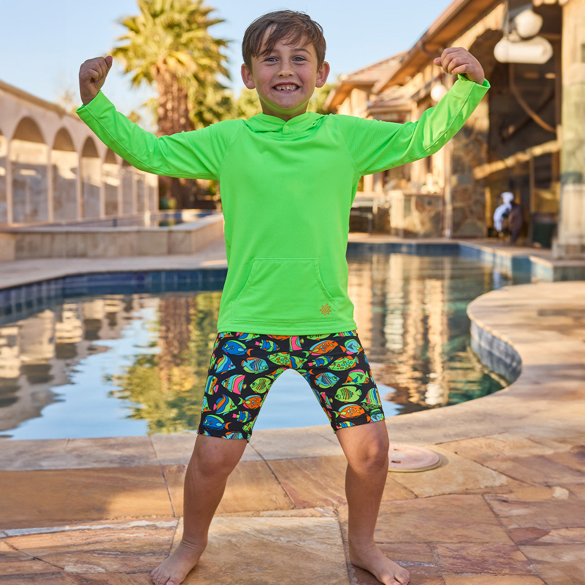 boy by pool in pullover hoodie|neon-green