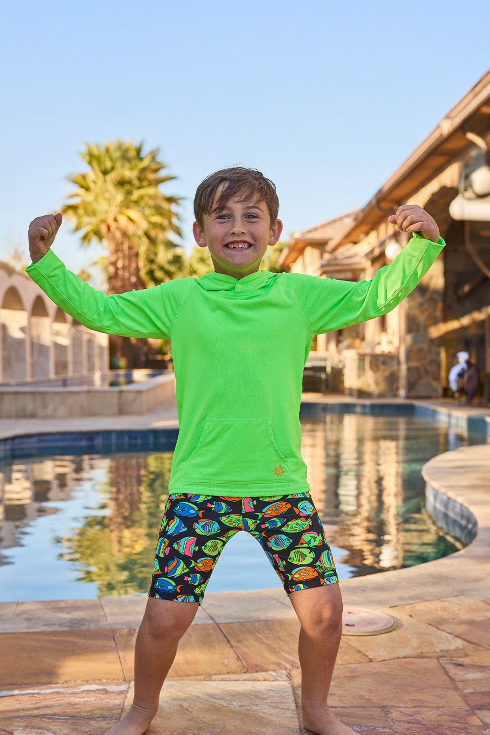 boy by pool in pullover hoodie|neon-green
