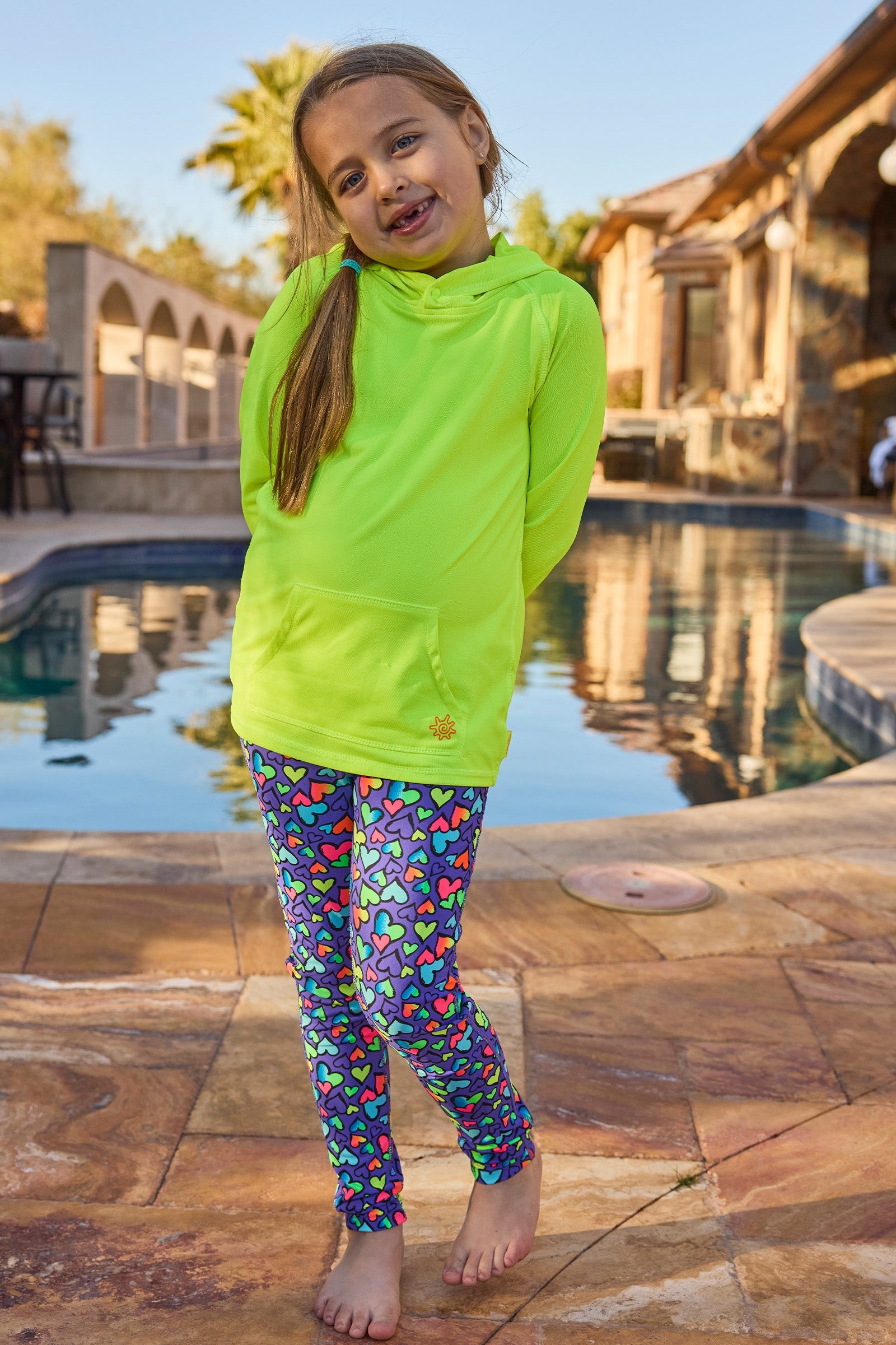 girl standing by pool in pullover hoodie|neon-yellow